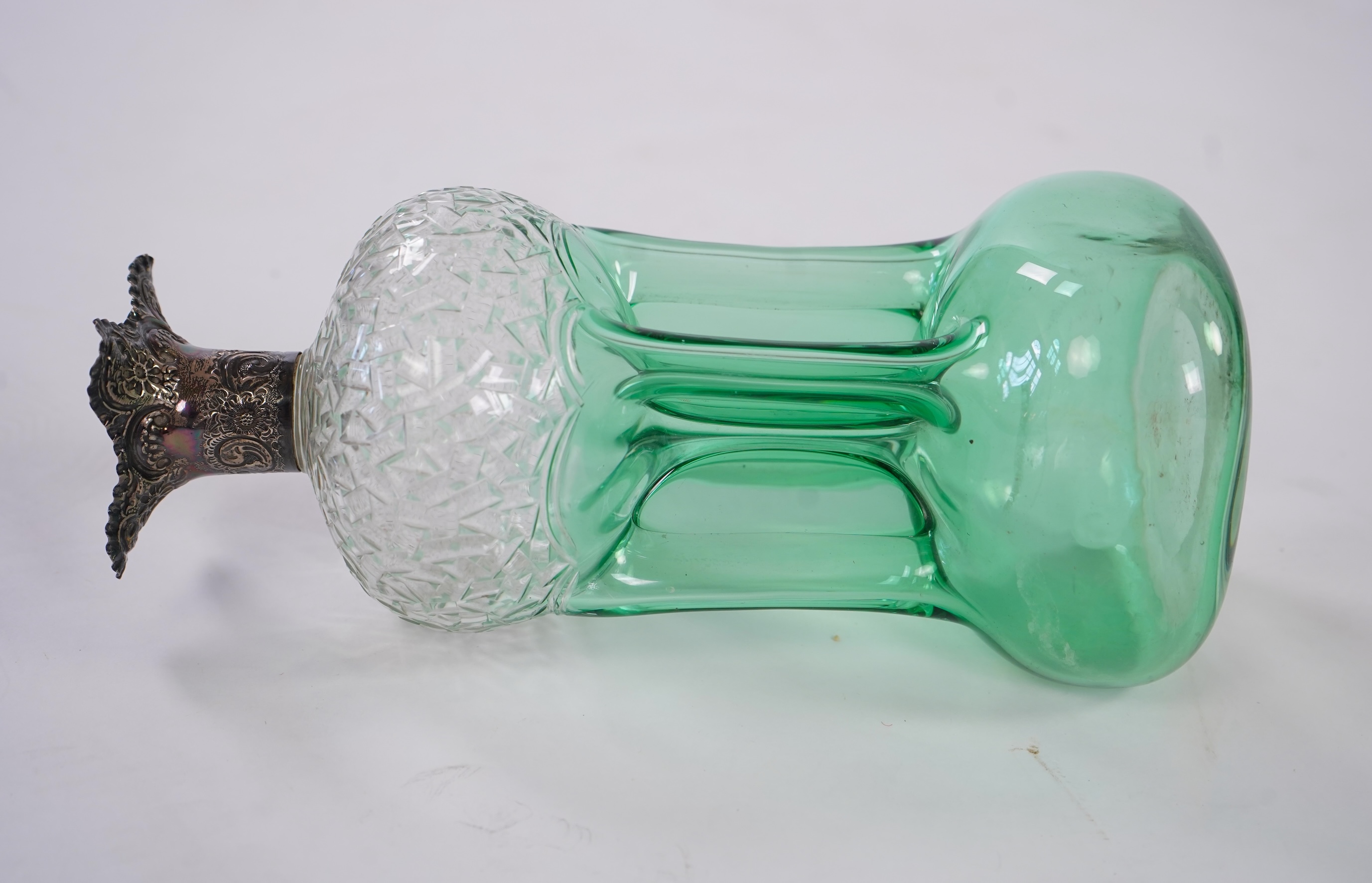 Attributed to Stevens and Williams of Stourbridge, a green flashed and cut pinched glass decanter